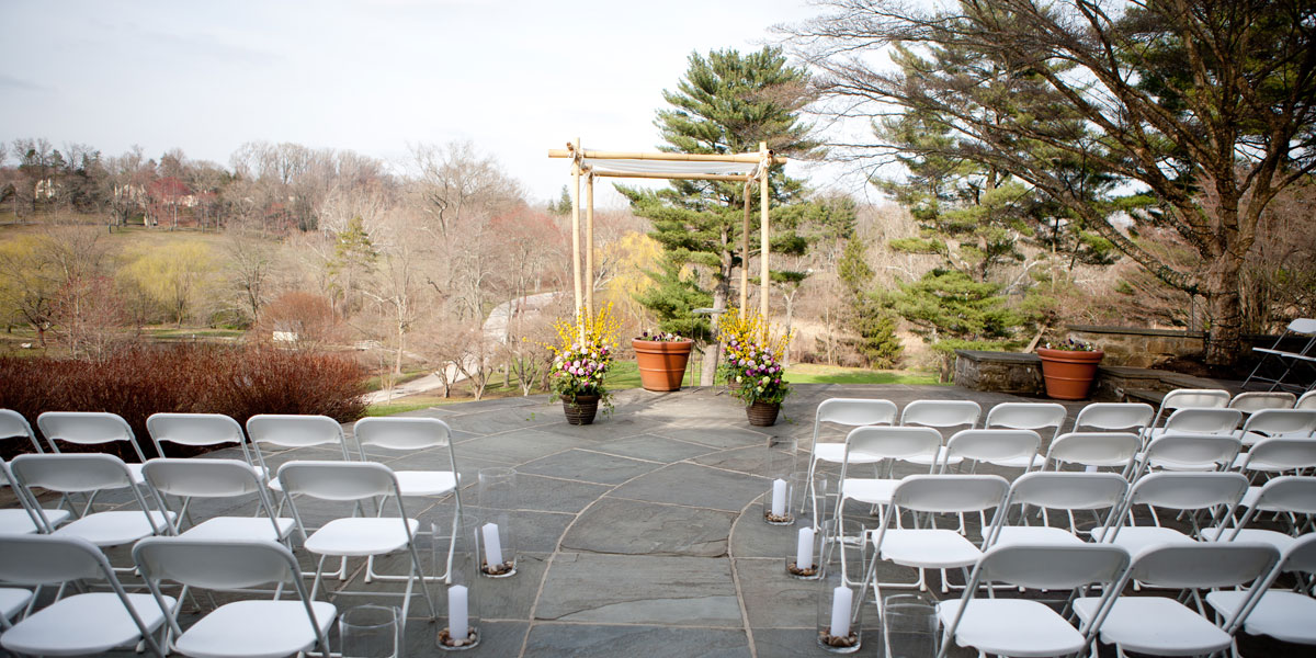 The aisle was lined with tall clear cylinder vases filled with river rocks